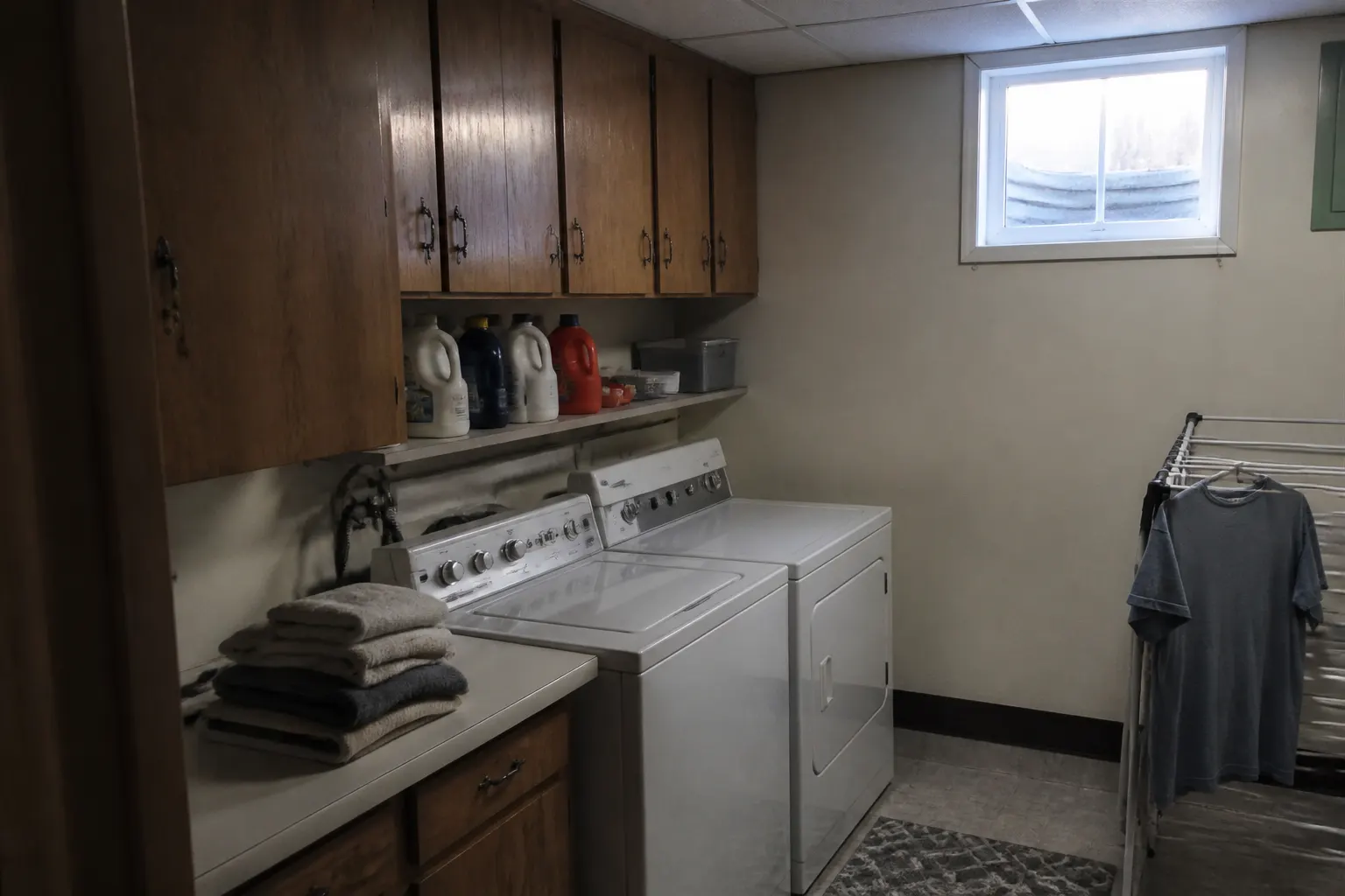 laundry room cabinets with folding counter above a washer and dryer